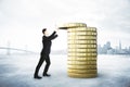 Man collects a stack of gold coins, saving money concept Royalty Free Stock Photo