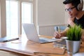 Man college student  studying learning lesson with computer online taking note Royalty Free Stock Photo