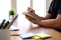 Man college student  studying learning lesson with computer online & taking note Royalty Free Stock Photo