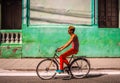 Man with colorful cloths riding a bike