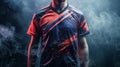A man in a colorful jersey stands in front of a smoky background