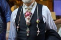 Man with colorful necklace with pearls, snail shells and gems before Versace fashion show, Milan Fashion Week Royalty Free Stock Photo