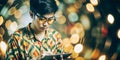 A man in a colorful shirt using a tablet with blurred lights in the background creating a dynamic and modern atmosphere