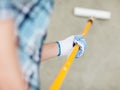 Man colouring the wall with roller