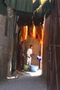 Workman is painting woolen threads in the Souk,Marrakech, Marocco