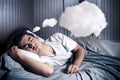 Man comfortably dreaming in his bed with a cloud Royalty Free Stock Photo