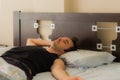 Man comfortably sleeping in his bed in the morning