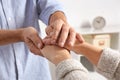 Man comforting woman on blurred background, closeup of hands.