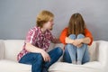 Woman confiding to man on sofa