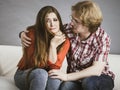 Woman confiding to man on sofa Royalty Free Stock Photo