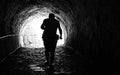 Man coming out of a dark tunnel. black and white Royalty Free Stock Photo
