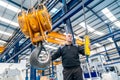 Man commanding the hook of an industrial crane