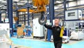 Man commanding the hook of an industrial crane