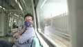 Man commuter with face mask on inside a moving subway train Royalty Free Stock Photo