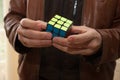 A man completing a Rubix cube