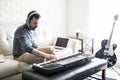 Man composing a song with electric piano