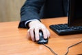 man at the computer, hand on the mouse Royalty Free Stock Photo
