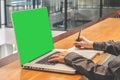 Man with computer, notebook, headset, paper book .business man with copy space for input the text with a green screen on monitor. Royalty Free Stock Photo