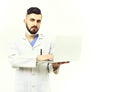 Man with concentrated face in white coat. Doctor with beard