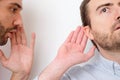 Man confessing a secret to another one in the air Royalty Free Stock Photo