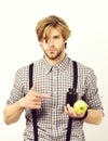 Man with confident face, beard and stylish hairdo holds apple Royalty Free Stock Photo