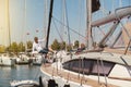 A man confidently standing on the deck of a luxury yacht overlooking the open water Royalty Free Stock Photo