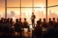 A man confidently stands in front of a diverse group of people, engaging them during a presentation, Group of business people in Royalty Free Stock Photo