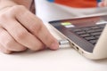 Man is connecting USB cable to laptop Royalty Free Stock Photo