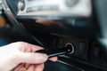 A man connects the device to the cigarette lighter of the car. T Royalty Free Stock Photo