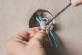 Man connects an electrical light switch to the wall - electrical work Royalty Free Stock Photo