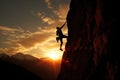 A man conquers the challenge of scaling a mountain as the golden sun sets in the background, Silhouette of Rock Climber at Sunset Royalty Free Stock Photo