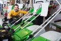 Man is considering the choice of lawnmowers Royalty Free Stock Photo