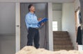 Man construction engineer writing note wear blue shirt safety white hard hat at construction site. Industry labour male worker. Royalty Free Stock Photo