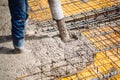 construction site, worker pouring concrete with pump tube