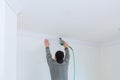 Man constructor renovates room interior with a plastic molding Royalty Free Stock Photo