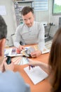 Man in consultation with couple holding colour charts Royalty Free Stock Photo