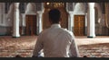 Man in contemplation at mosque. peaceful prayer moment. serene worship space. reflective spiritual practice in holy Royalty Free Stock Photo