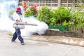 Man control Mosquito sprayer killing insects and fogging to eliminate mosquito for preventing spread dengue fever and zika virus.