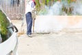 Man control Mosquito sprayer killing insects and fogging to eliminate mosquito for preventing spread dengue fever and zika virus.