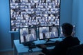 Man in control room monitoring cctv footage Royalty Free Stock Photo