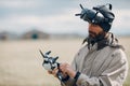 Man controlling fpv quadcopter drone with goggles antenna remote controller Royalty Free Stock Photo