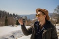 Man controls the flying drones in snowy forest winter. Adventurous winter holiday Royalty Free Stock Photo