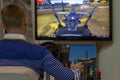 A man controls tractor simulator - an excavator, rear view.