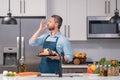 Man in cook apron preparing seafood at home modern kitchen. Man chefs with sign of perfect food. Chef man cooking