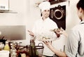 Man cook giving to waitress ready to serve salad Royalty Free Stock Photo