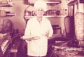 Man cook making kebab dish on kitchen in fast food restaurant Royalty Free Stock Photo