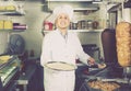 Man cook making kebab dish on kitchen in fast food restaurant Royalty Free Stock Photo