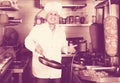 Man cook making kebab dish on kitchen in fast food restaurant Royalty Free Stock Photo