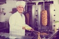 Man cook making kebab dish on kitchen in fast food restaurant Royalty Free Stock Photo