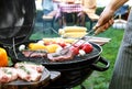 Man cooking on barbecue grill outdoors Royalty Free Stock Photo